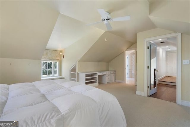 bedroom featuring ceiling fan, light carpet, and lofted ceiling