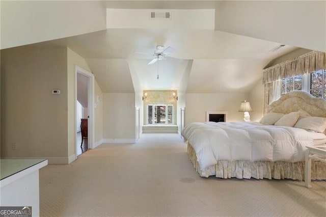 bedroom with light colored carpet and lofted ceiling