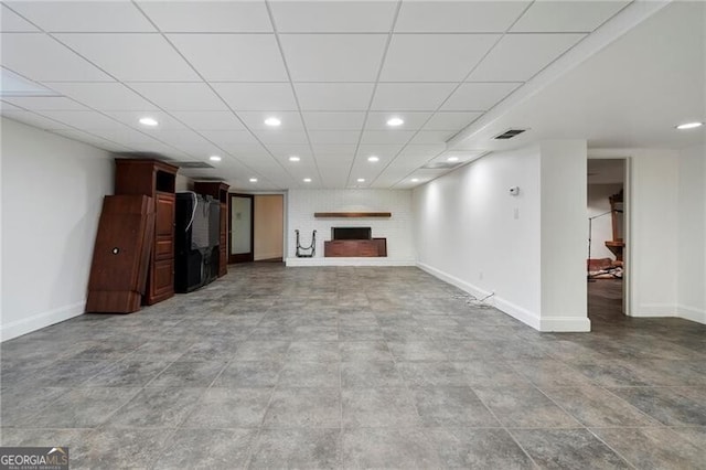 unfurnished living room featuring a drop ceiling