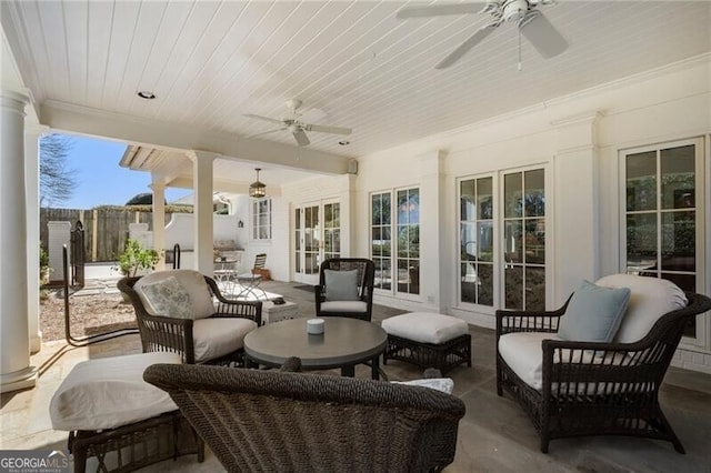 view of patio with an outdoor living space and ceiling fan