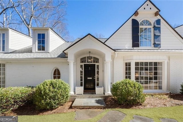 doorway to property featuring a lawn