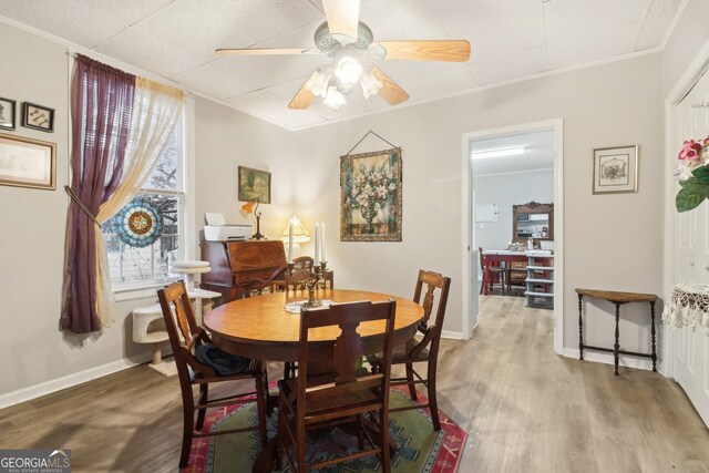 dining area featuring ornamental molding, ceiling fan, and wood-type flooring