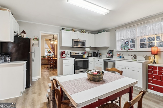 kitchen featuring white cabinets, light hardwood / wood-style flooring, stainless steel appliances, and sink