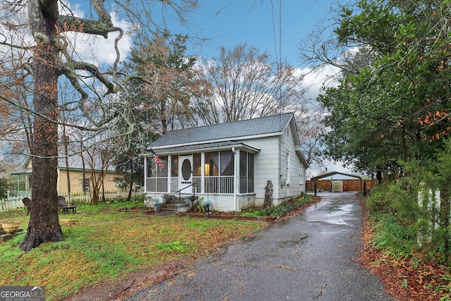 bungalow-style house with a sunroom and a carport