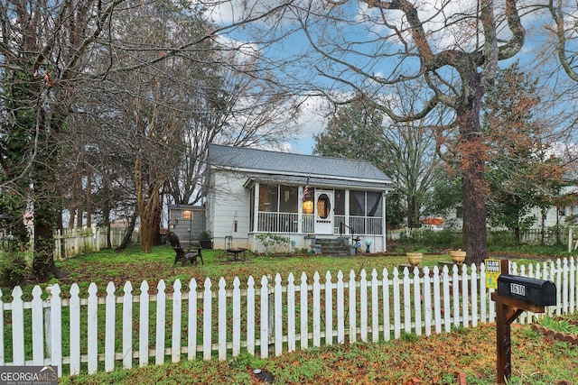 view of front of home featuring a front yard and a sunroom