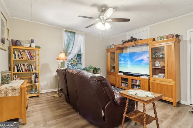 living room with ceiling fan, light wood-type flooring, and crown molding