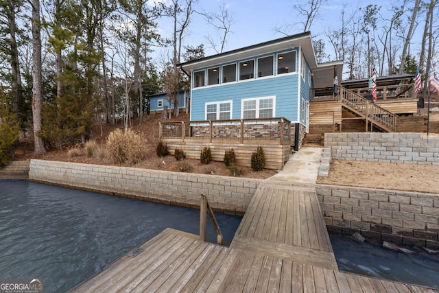 rear view of property with stairway