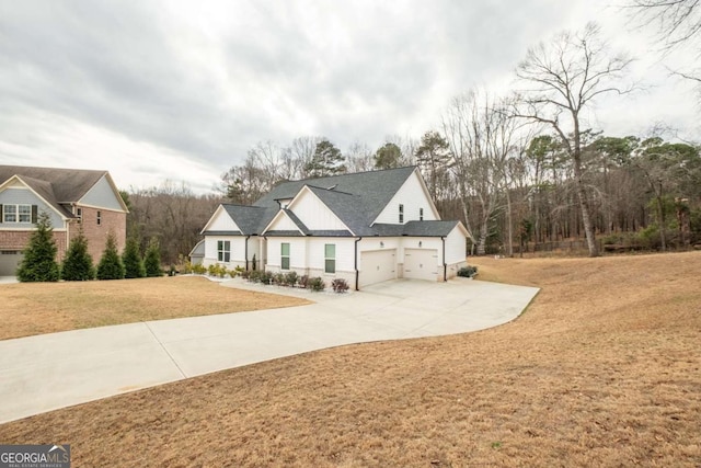 view of front of property with a front yard and a garage