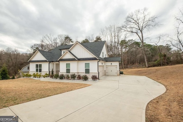 view of front of property with a garage and a front lawn