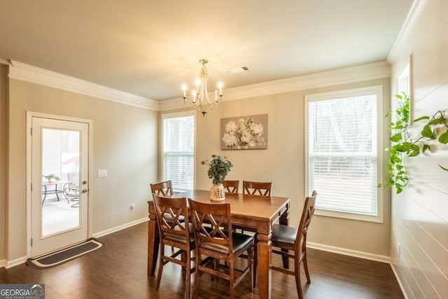 dining area with dark wood-type flooring, a chandelier, and crown molding