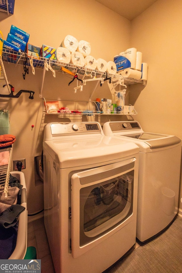 clothes washing area with washing machine and clothes dryer