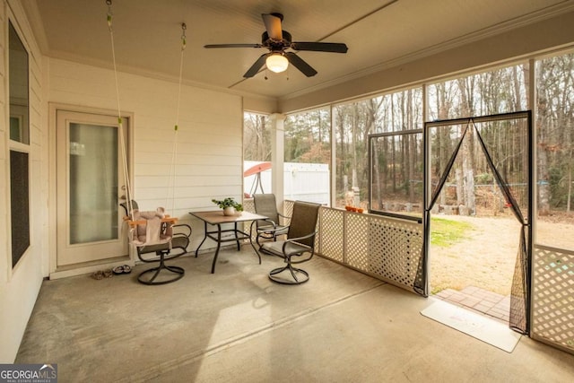 sunroom / solarium featuring ceiling fan