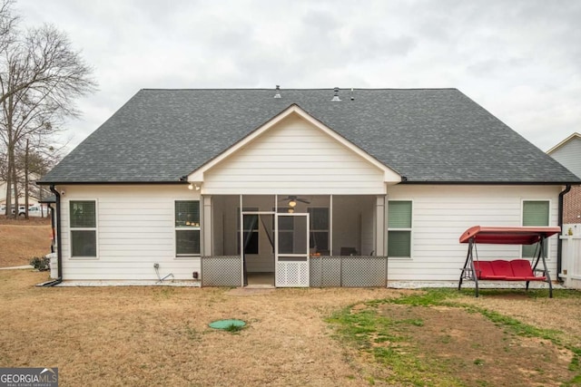 back of house featuring a yard, a sunroom, and ceiling fan