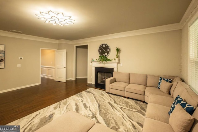 living room featuring dark hardwood / wood-style flooring and ornamental molding