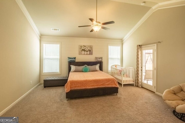 carpeted bedroom featuring ornamental molding, vaulted ceiling, and ceiling fan