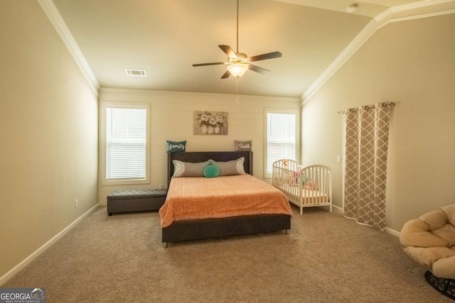 bedroom with ceiling fan, vaulted ceiling, crown molding, and carpet flooring