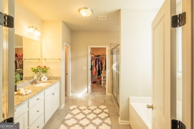 bathroom with independent shower and bath and vanity