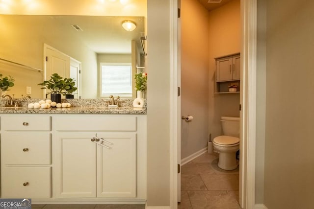 bathroom with toilet and vanity