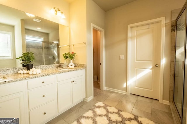 bathroom with vanity and a shower with shower door