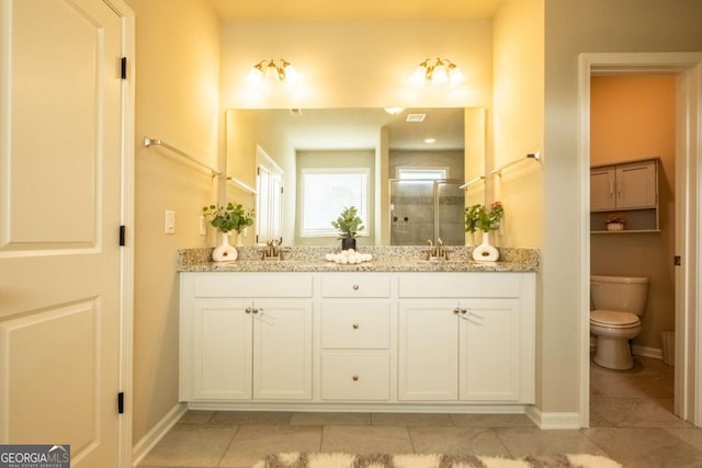 bathroom featuring vanity, toilet, tile patterned floors, and walk in shower