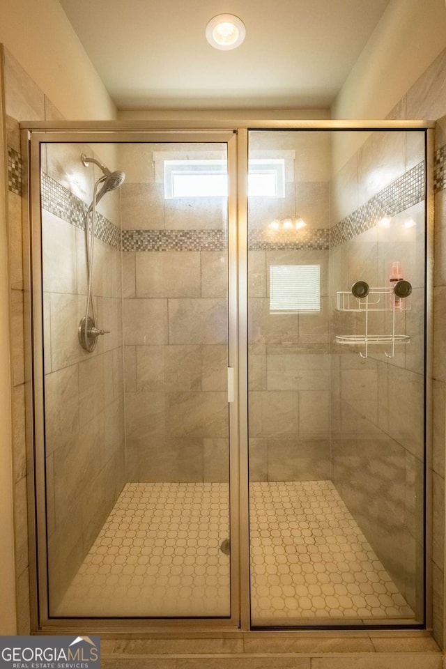 bathroom with a shower with shower door