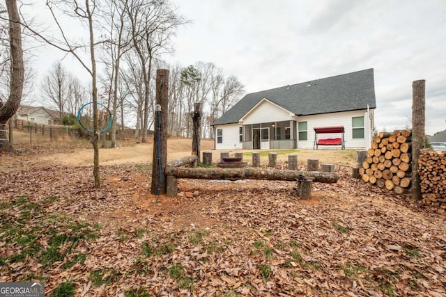 rear view of property with a sunroom