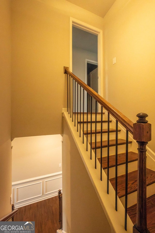 staircase featuring wood-type flooring