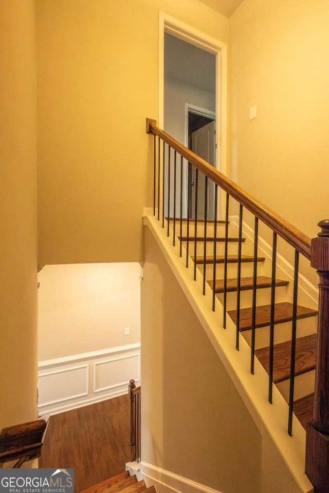 stairway featuring hardwood / wood-style floors