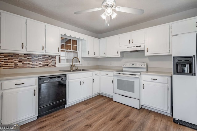 kitchen featuring sink, white appliances, hardwood / wood-style flooring, and white cabinetry