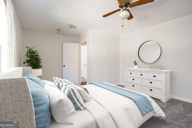 carpeted bedroom featuring a textured ceiling and ceiling fan