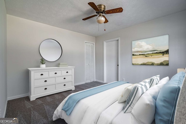 carpeted bedroom featuring a textured ceiling, a closet, and ceiling fan