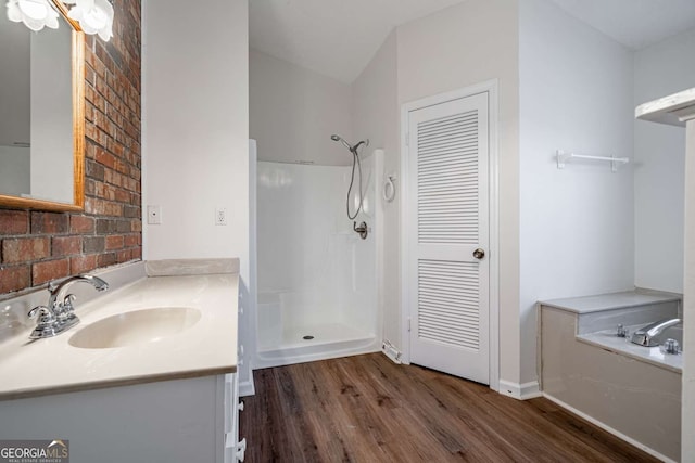 bathroom with hardwood / wood-style flooring, vanity, and a shower