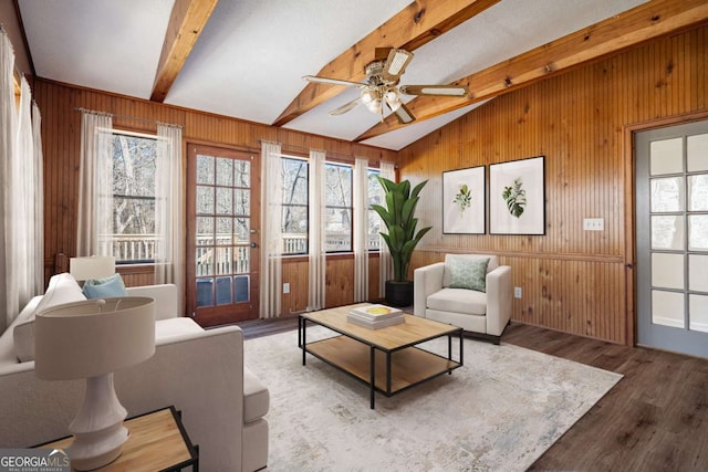 sunroom with ceiling fan and lofted ceiling with beams