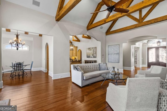 4080 Ryckeley Dr, Gainesville, GA 30504 - living area with ceiling fan with notable chandelier, arched walkways, wood-type flooring, and high vaulted ceiling
