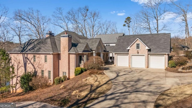 view of front of house featuring driveway and a chimney