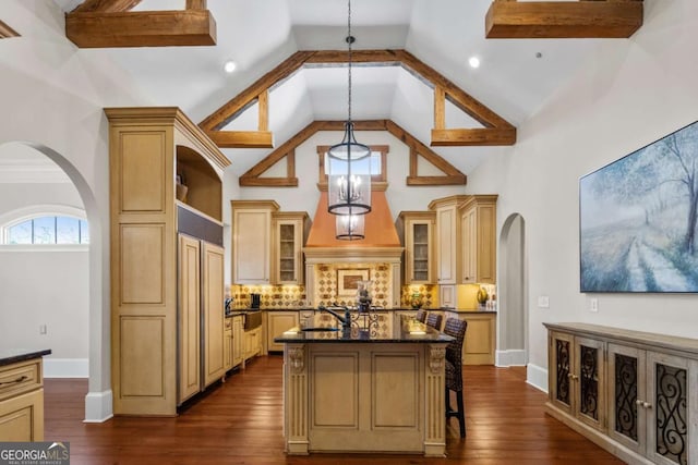 4080 Ryckeley Dr, Gainesville, GA 30504 - kitchen with a center island, glass insert cabinets, dark wood-style floors, arched walkways, and high vaulted ceiling