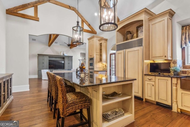 4080 Ryckeley Dr, Gainesville, GA 30504 - kitchen featuring tasteful backsplash, a kitchen island, dark wood-type flooring, dark stone countertops, and open shelves