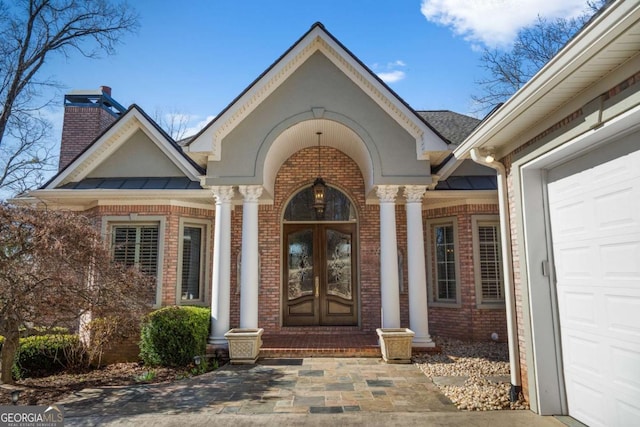 4080 Ryckeley Dr, Gainesville, GA 30504 - view of exterior entry featuring french doors, brick siding, and a chimney