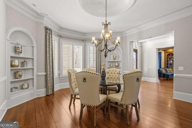 4080 Ryckeley Dr, Gainesville, GA 30504 - dining room with baseboards, an inviting chandelier, ornamental molding, and hardwood / wood-style flooring
