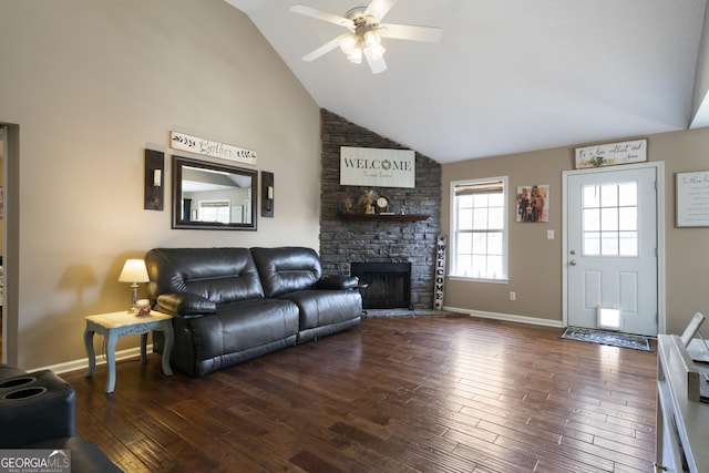 living room featuring a fireplace, dark wood-type flooring, high vaulted ceiling, and ceiling fan