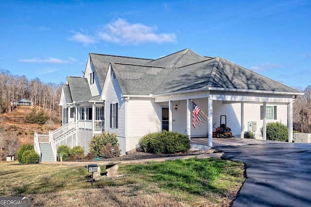 view of front of house with a front lawn and a carport