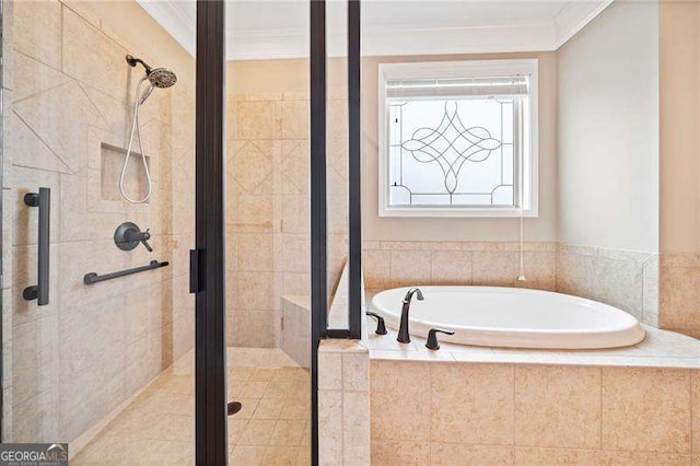 bathroom with a stall shower, a bath, and crown molding