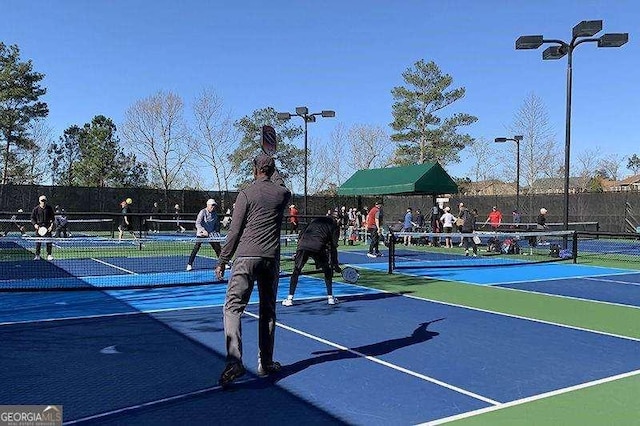 view of tennis court with fence