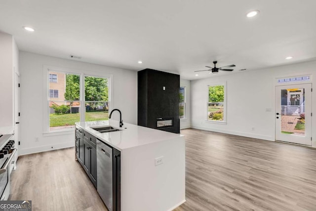 kitchen featuring a center island with sink, light hardwood / wood-style flooring, plenty of natural light, stainless steel appliances, and sink