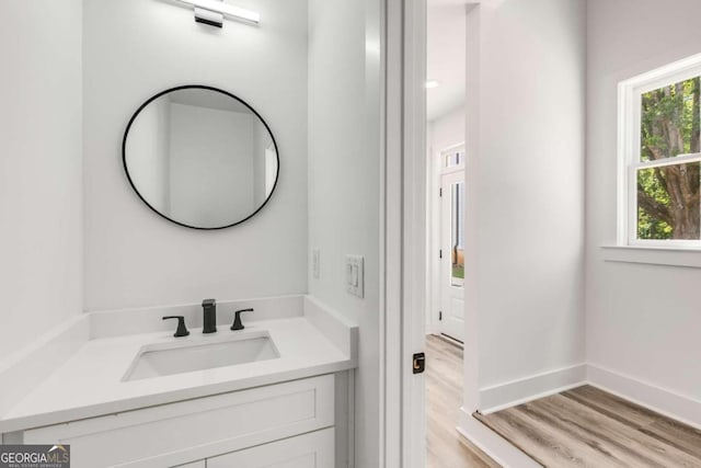 bathroom featuring hardwood / wood-style flooring and vanity