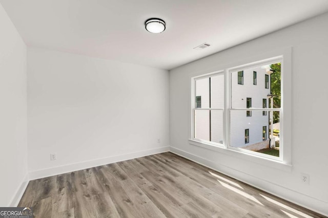 spare room with light wood-type flooring