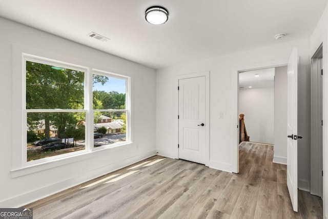 unfurnished bedroom with light wood-type flooring