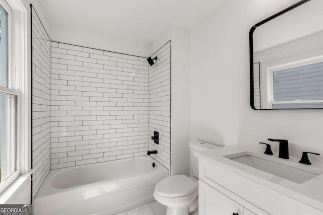 full bathroom featuring toilet, vanity, and tiled shower / bath