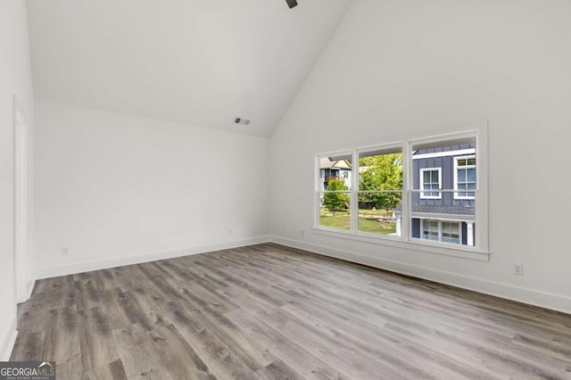 interior space featuring high vaulted ceiling and light hardwood / wood-style flooring