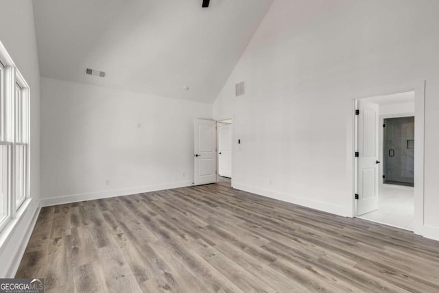 interior space featuring high vaulted ceiling and light hardwood / wood-style flooring